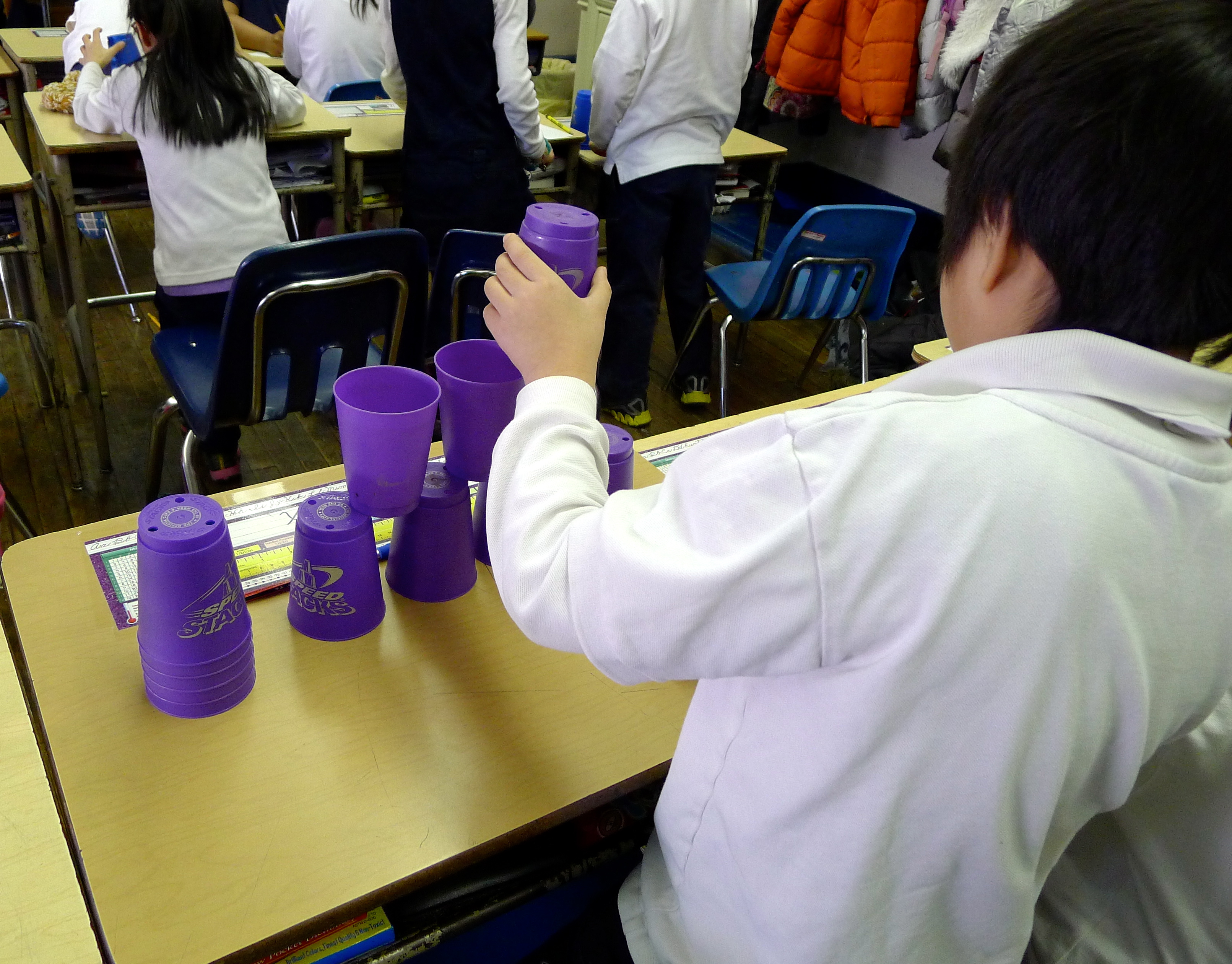 Student "robot" following code to stack cups